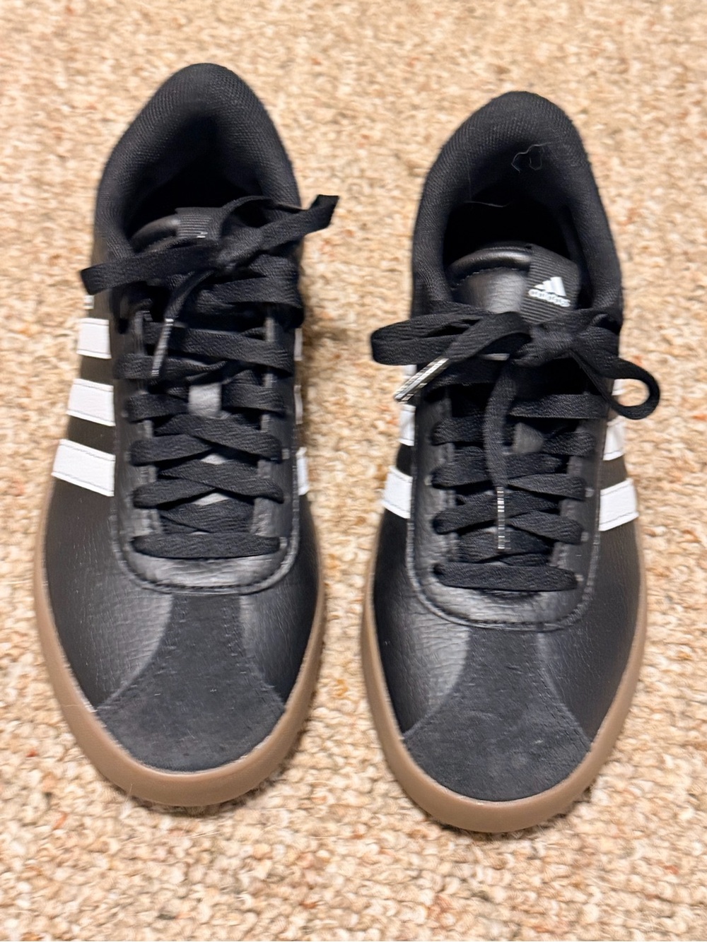 adidas Womenโs Black Sneakers with White Stripes and Brown Sole